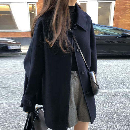 Manteau mi-long en laine à revers et boutonnage simple